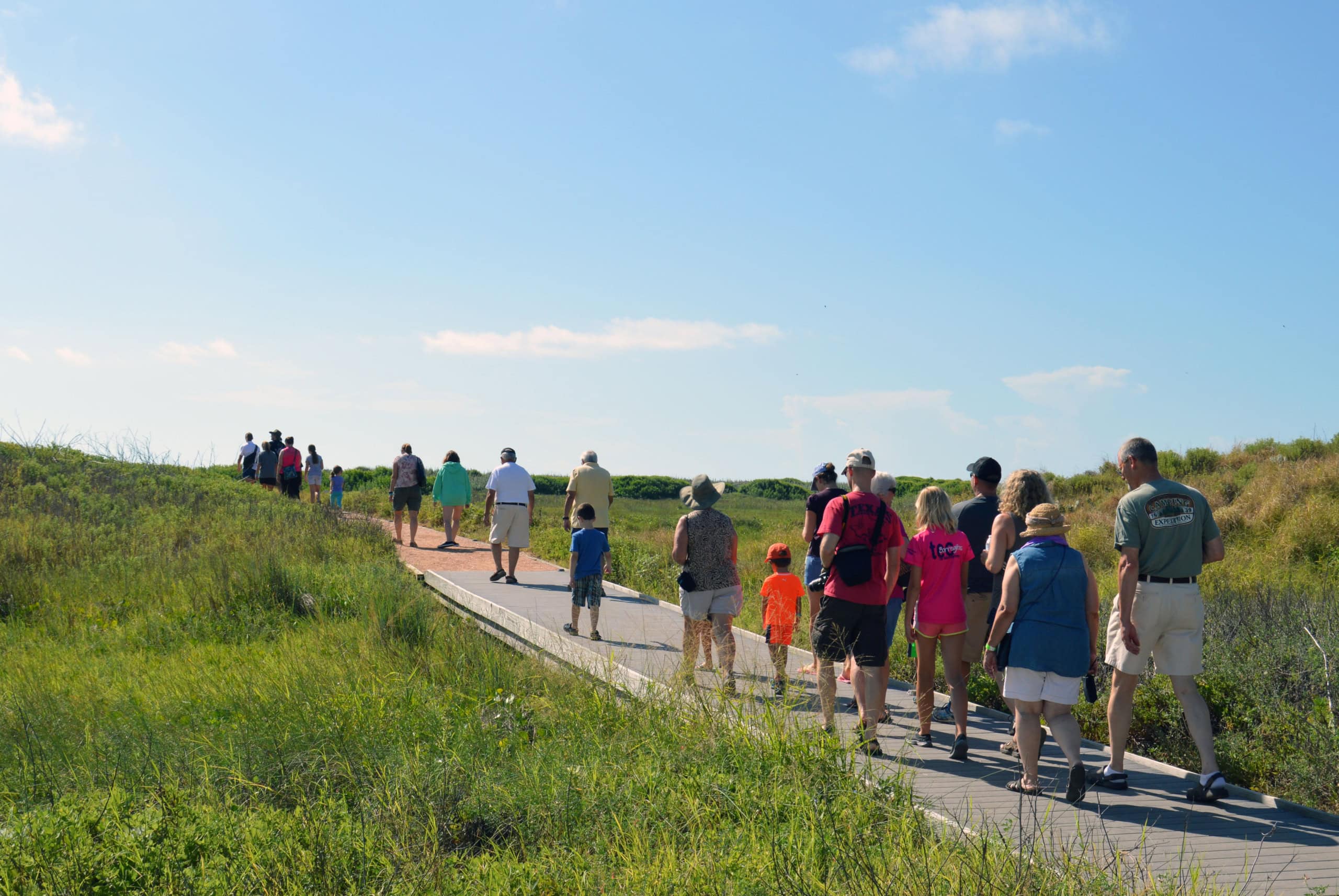 People walking the Wetlands Education Center trail.